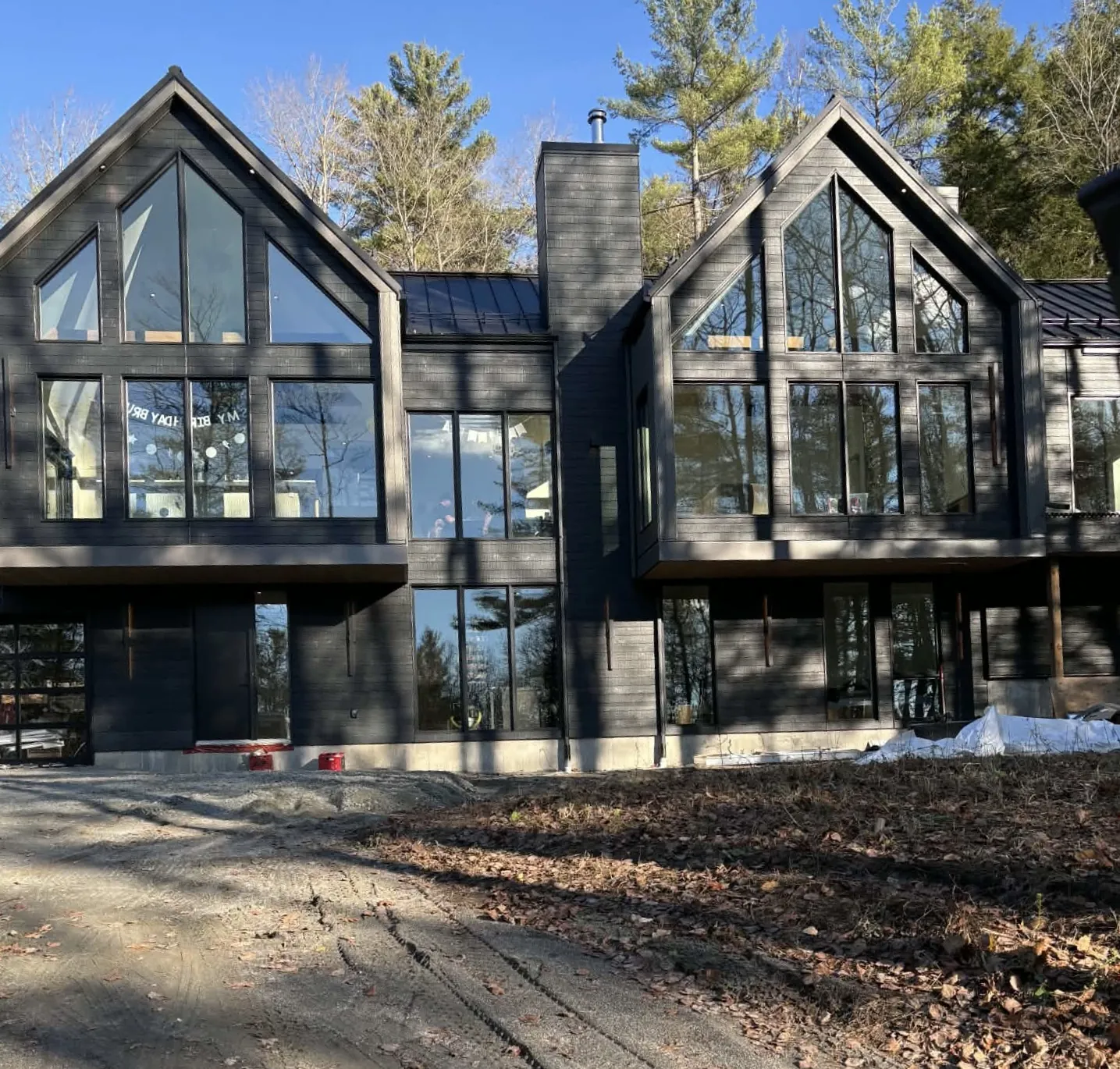 Modern black home in Cumberland, Ottawa with CanExel V-Joint siding and tall glass gables
