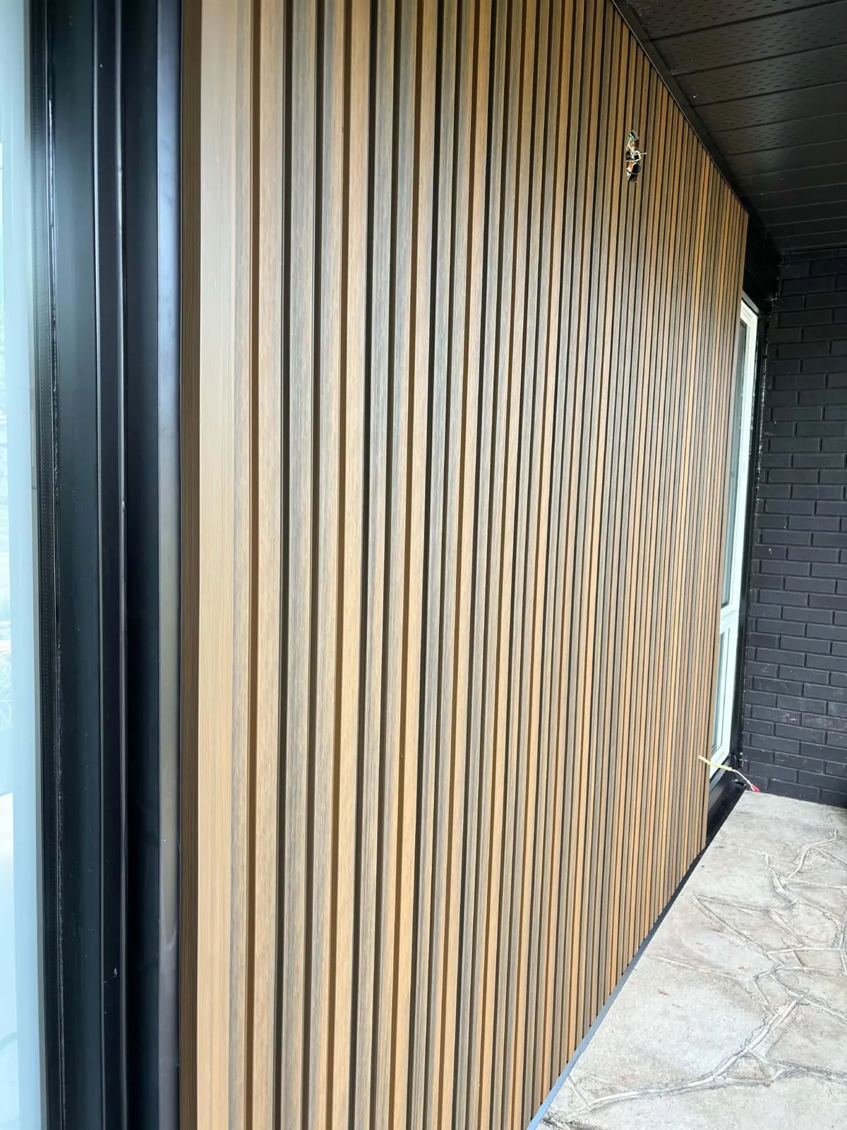 Close-up of Fiberwood fluted wood siding ribs and clean trim edges on a Nepean home