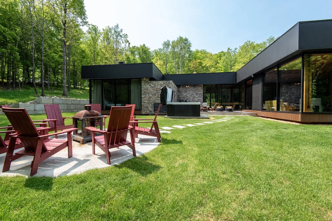 Backyard patio with seating area beside a modern home